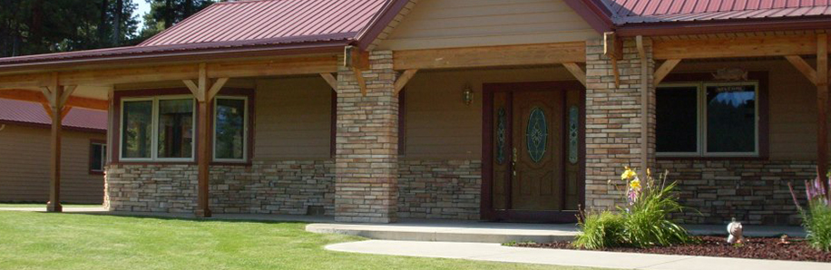 Image of a home with a Red Metal Roof and Brand New SIding, provided by Thelen Custom Home Builders